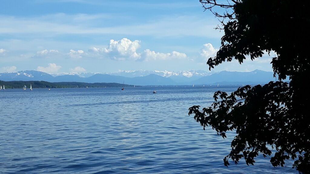 a body of water with mountains in the background
