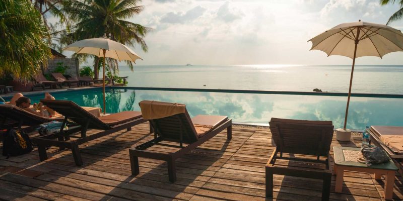 loungers, pool, palms, oceanview